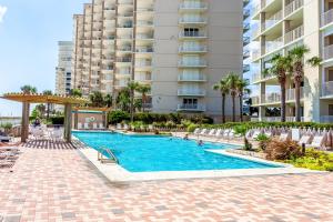 a swimming pool in front of a large apartment building at White Caps 203 in Orange Beach