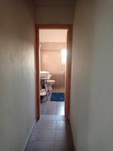 a hallway leading to a bathroom with a sink at Seaside resort- kallithea in Kallithéa +26 photos