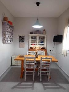a dining room with a wooden table and chairs at Seaside resort- kallithea in Kallithéa