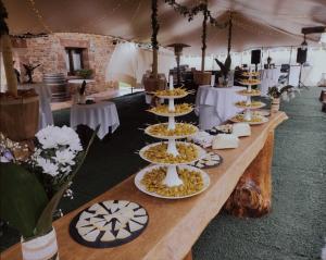 a long table with plates of food on it at Lezamakoetxe in Sopuerta