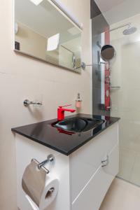 a bathroom with a sink and a mirror at Residences Bellavista 3 in Novalja