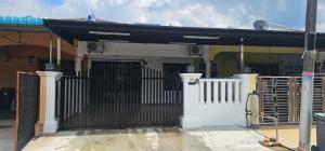 a white gate in front of a house at 4 bedroom homestay @ Mersing in Mersing