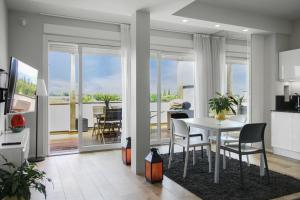 a kitchen and living room with a table and chairs at Appartamento VITTORIA in Verona