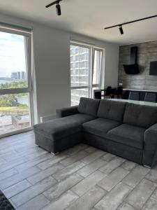 a living room with a couch and a table at 4 rooms apartment with a view to the Dnieper River in Kyiv