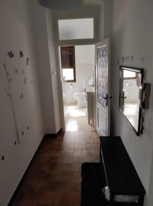 a hallway with a bathroom with a toilet and a mirror at ArenaApp in Pula +13 photos