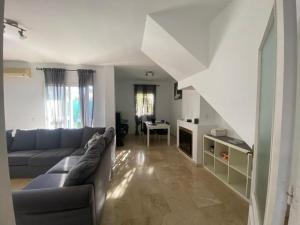 a living room with a couch and a table at Villa Almenso in Seville