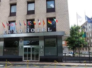 a building with a bunch of flags in front of it at Eurohotel in Nichelino