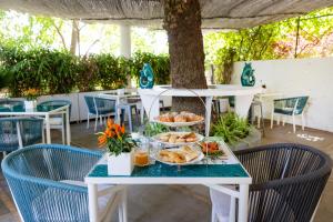 a table with plates of food on it at Villa La Pergola Capri in Capri