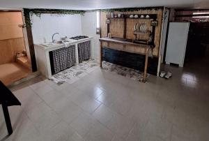 a kitchen with a sink and a refrigerator at Taberna di felisiano in Torre Canne