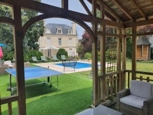 um gazebo aberto com uma mesa de pingue-pongue no quintal em LES 5 ESCALES em Parthenay