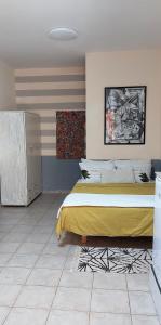 a bedroom with a large bed with a yellow blanket at Hanna's Place - Great Location in Eilat