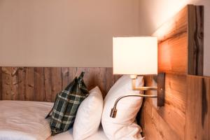 a bedroom with a bed with a lamp and pillows at Hotel & Restaurant Zum Reussenstein in Böblingen