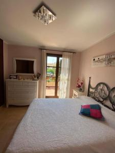 a bedroom with a large bed and a television at Casa con jardín en Roda de Bará in Roda de Bará +17 photos