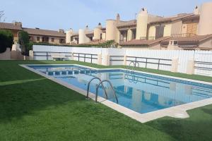 a swimming pool in the middle of a yard at Casa con jardín en Roda de Bará in Roda de Bará