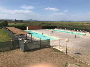 a large swimming pool in the middle of a field at Residence il Tombolo in Principina a Mare