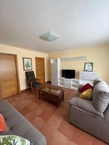 a living room with a couch and a table at Casa Marina in Cerdido
