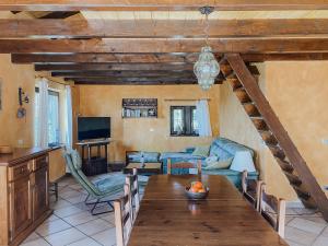 a living room with a table and a couch at Ca’ Ai Monti in Trarego
