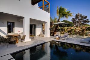 a villa with a swimming pool and a house at Clementina Paros in Kampos Paros