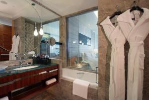 a bathroom with a tub and a sink and a mirror at InterContinental Foshan, an IHG Hotel - Free Shuttle Bus for Canton Fair in Foshan