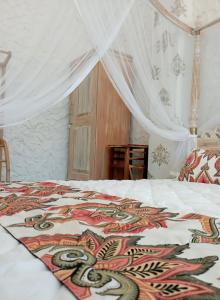 a bedroom with a bed with a blanket on it at Villa Music of the ocean in Wadduwa