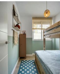 a bedroom with a bunk bed and a blue rug at Casa Xava Valencia in Valencia