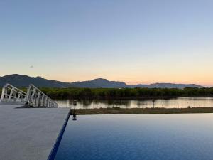 a bridge over a body of water with mountains in the background at Lake Side Villa in Nadi