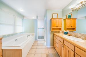 a bathroom with a tub and a sink at The Lilikoi - Entire home in Kailua-Kona