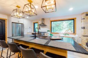 a kitchen with a large island with chairs around it at The Wedshire in Vail