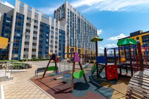 a playground in front of a large building at ЖК "Light House", 1 in Astana