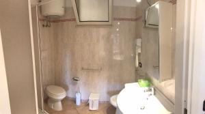 a bathroom with a toilet and a sink at Residence il Tombolo in Principina a Mare