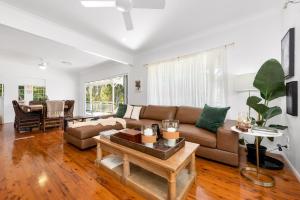 a living room with a couch and a table at The Stables Luxury Country Escape in Canungra