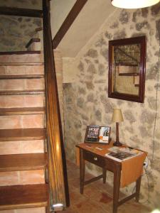a room with a desk and a staircase with a table at La Serranilla in San Esteban de la Sierra