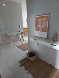 a room with a picture on the wall and a table at Centrally located apartment 2 in Volos