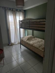 2 łóżka piętrowe w pokoju z oknem w obiekcie Centrally located apartment 2 w mieście Wolos