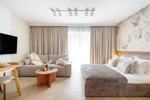a bedroom with a large bed and a couch at MUSE - LoftAffair Collection in Kraków