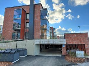 an empty parking lot in front of a brick building at Loft apartment with lake views in Tampere
