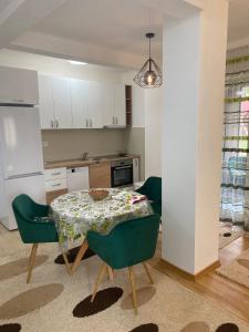 a kitchen and dining room with a table and chairs at Pirlitor Mountain Apartment in Žabljak