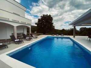 a swimming pool in front of a house at Villa Ramljak in Mostar