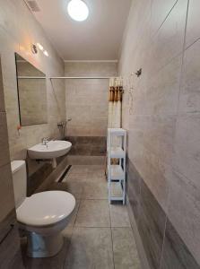 a bathroom with a toilet and a sink and a mirror at Emides in Pobierowo +20 photos