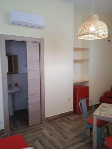 a living room with a table and a mirror at RAYO DE SOL in Marina di Casalvelino +10 photos