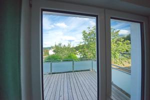 a sliding glass door with a view of a balcony at Burgblick-merzalben in Merzalben