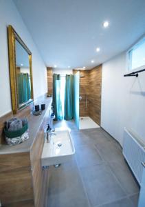 a bathroom with a white sink and a shower at Burgblick-merzalben in Merzalben