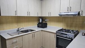 a kitchen with a sink and a stove at Sea view near the beach 2 in Ras al Khaimah