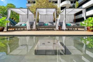 a swimming pool with lounge chairs and a swimming pool at HOVIMA Suites Costa Adeje in Adeje