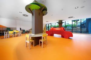 a childrens play area with a table and a red slide at HOVIMA Suites Costa Adeje in Adeje