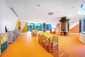 a classroom with a table and chairs and a library at HOVIMA Suites Costa Adeje in Adeje