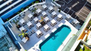an overhead view of a pool with tables and chairs at HOVIMA Suites Costa Adeje in Adeje