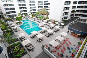 an overhead view of a pool with tables and chairs at HOVIMA Suites Costa Adeje in Adeje