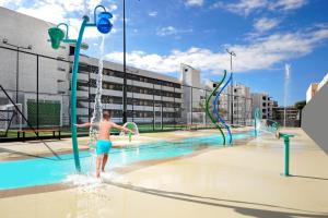 a young boy playing in a water park at HOVIMA Suites Costa Adeje in Adeje