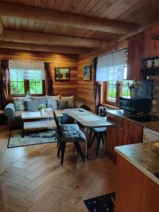 a living room with a couch and a table at Zbójecko Chata in Bukowina Tatrzańska